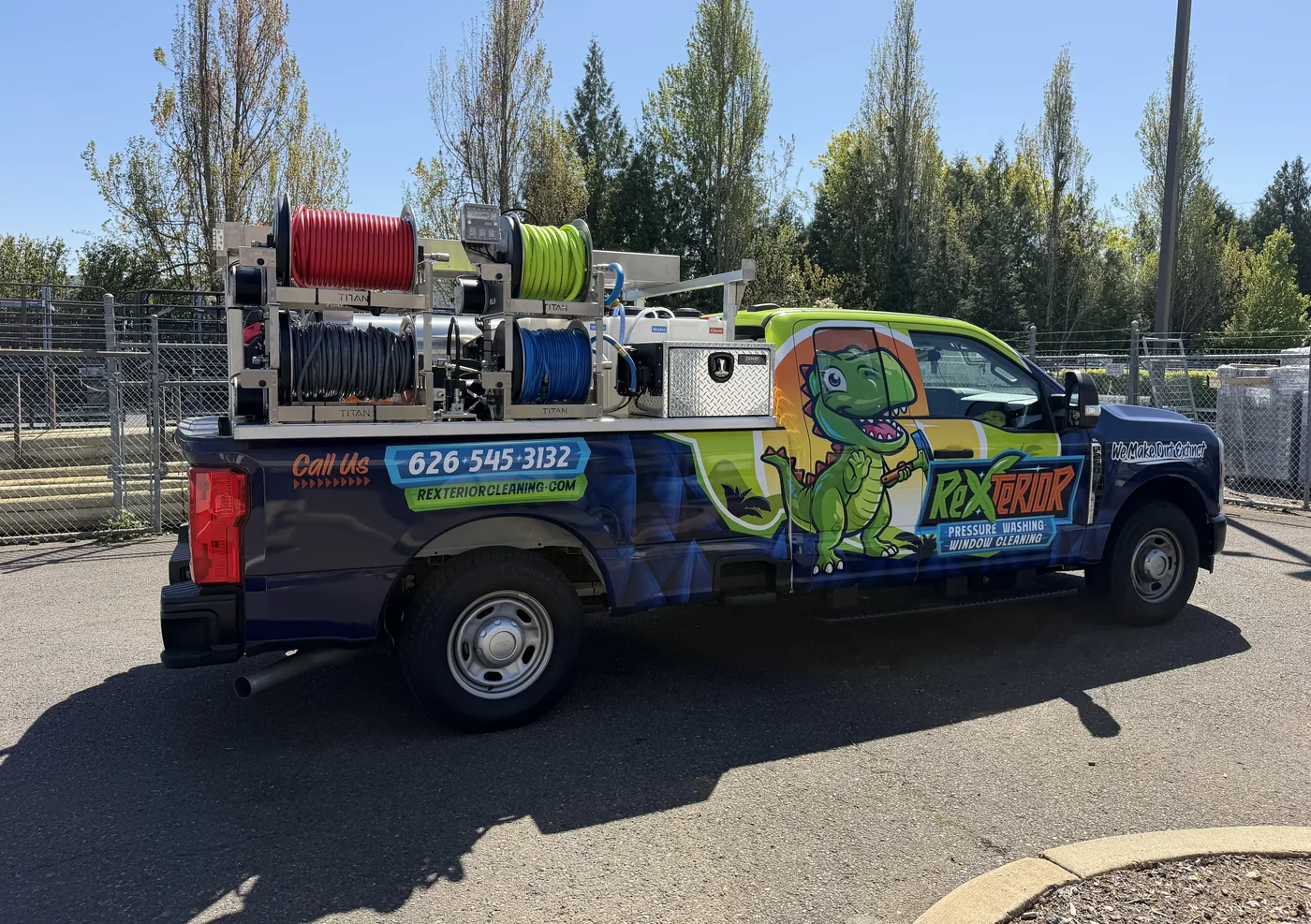 Fully organized Rexterior equipment system mounted on the truck bed, hose reels and tanks visible