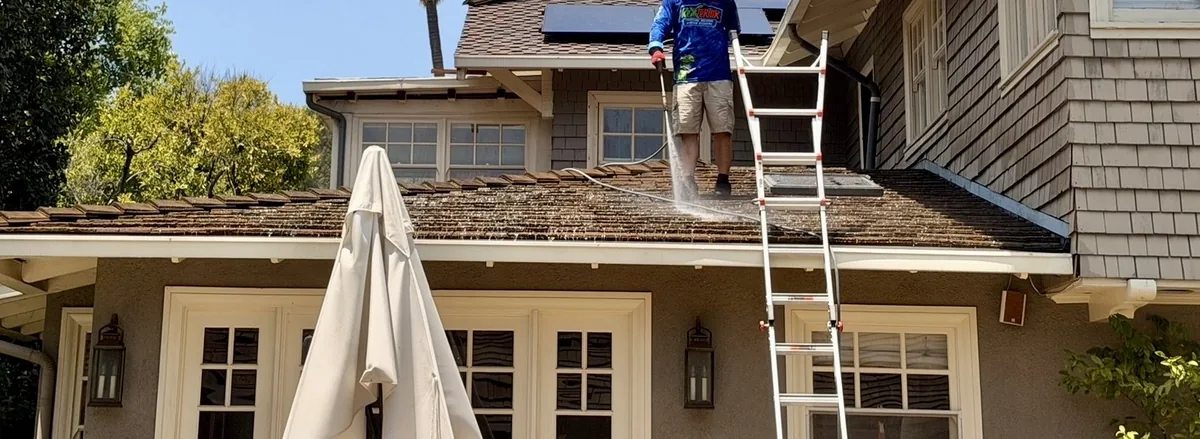 Rexterior technician cleaning a residential tile roof