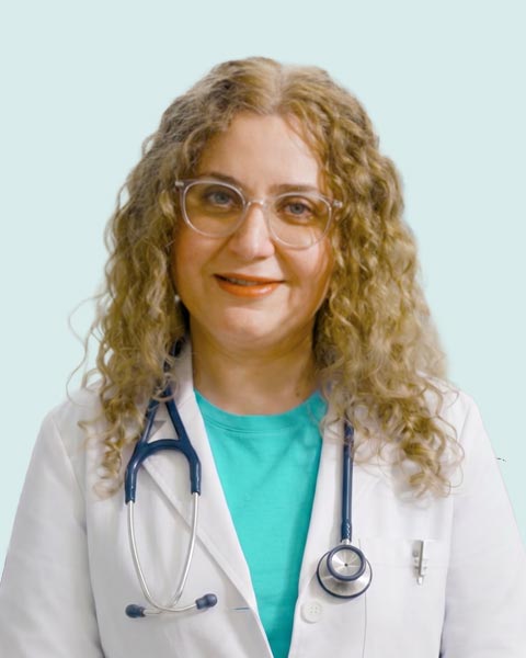 Doctor Maalouf with an stethoscope around her neck smiling.