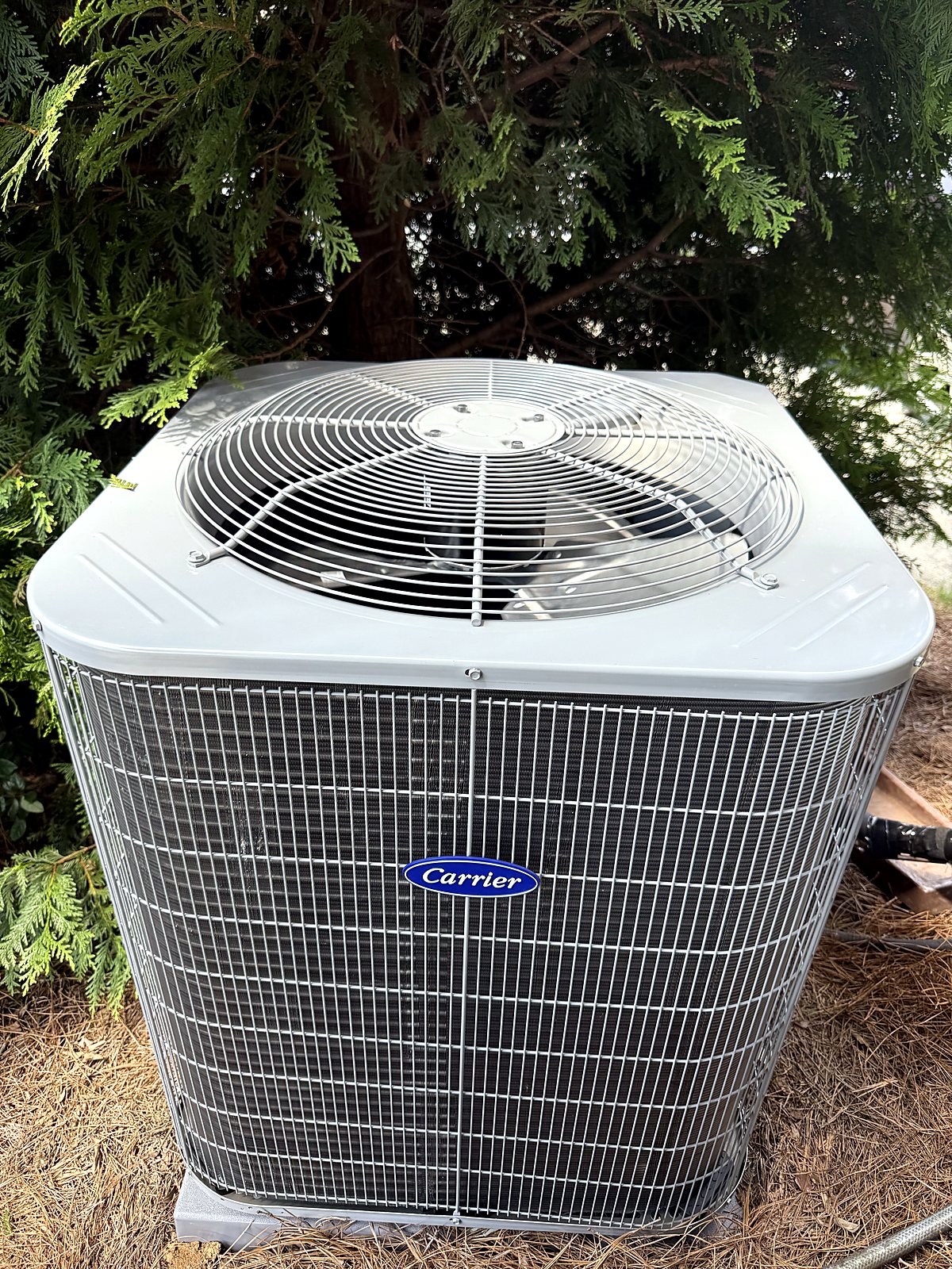 Newly installed Carrier AC condenser beside a metro Atlanta home