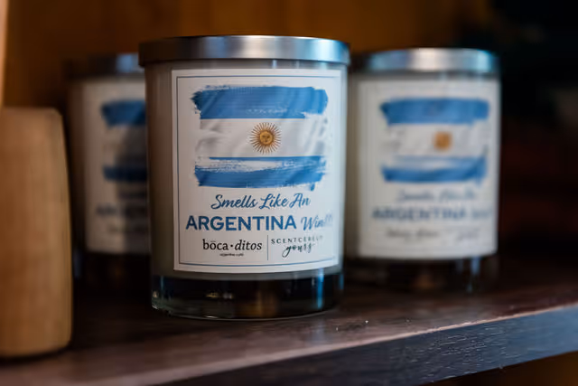 Scented candle jar labeled 'Smells Like An ARGENTINA Win!!!' with blue and white Argentina flag image.