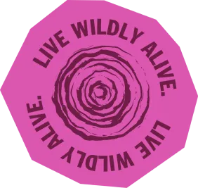 Pink badge with dark text reading live wildly alive surrounding a tree ring pattern.