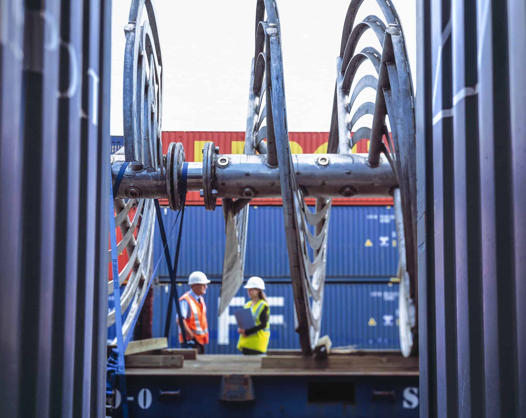 engineers talking together in container yard