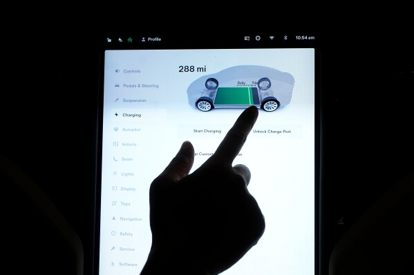 The charging status screen is shown on a Tesla car at a home in San Francisco, Aug. 25, 2022. (AP Photo/Jeff Chiu, File)