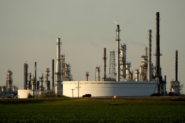 A motorist drives past the CHS oil refinery Sept. 28, 2024, in McPherson, Kan. (AP Photo/Charlie Riedel, File)