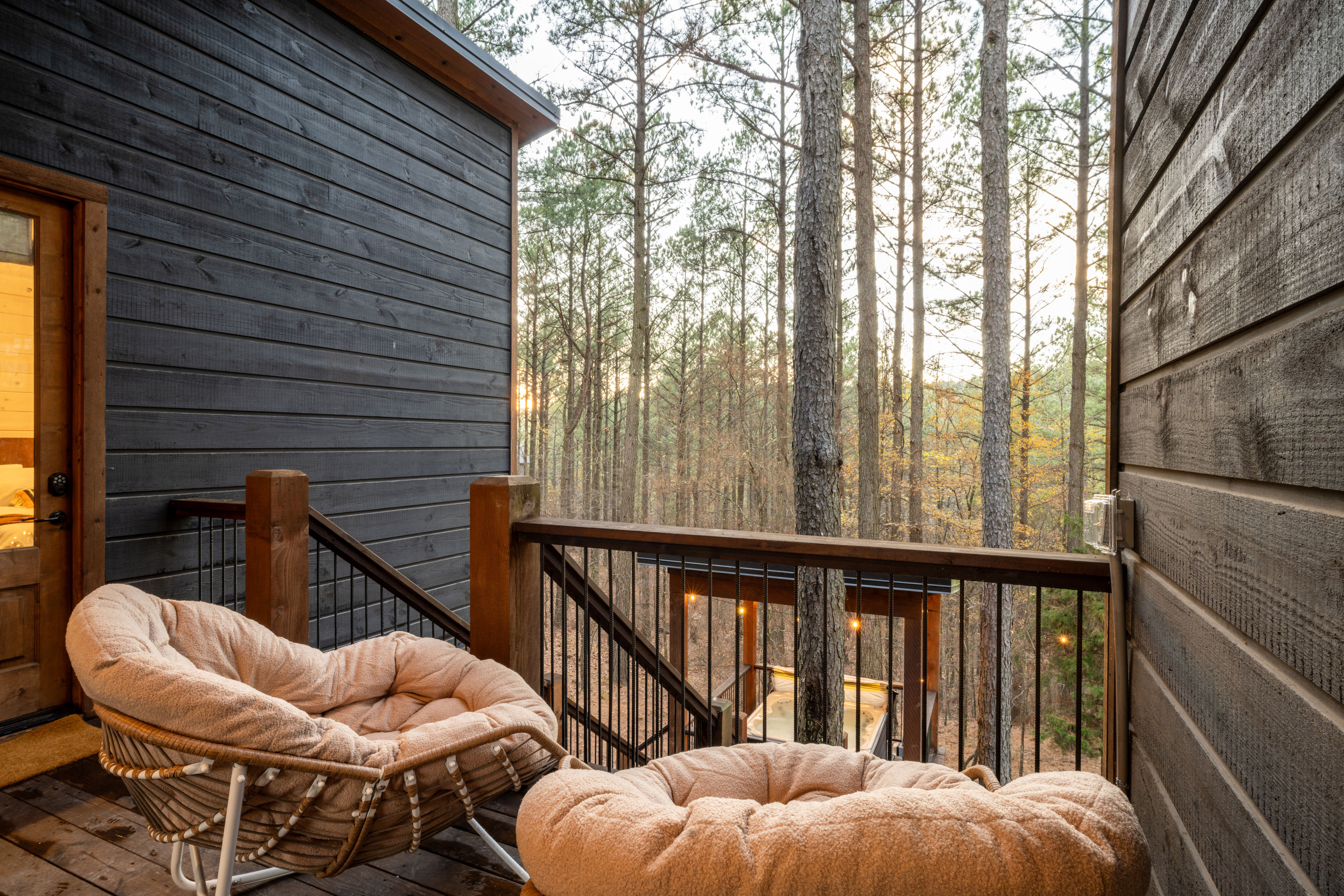 Take in the tall trees from the back of the patio while you sink into a large cushioned outdoor rocking chair. 