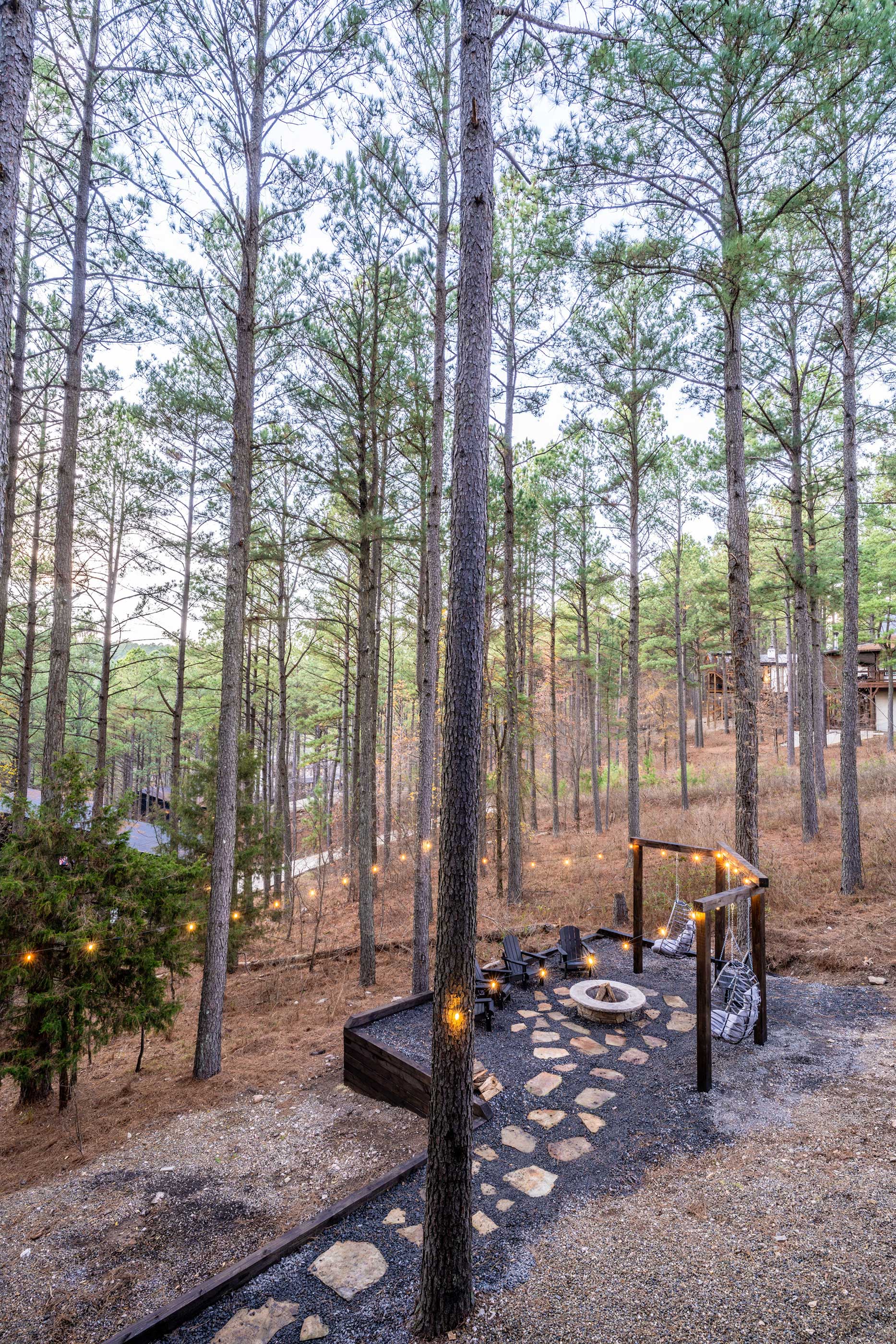 The fire pit area features a beautiful flagstone walking path that leads to the seating area. Enjoy a fire or simply relax below the towering pine trees. 