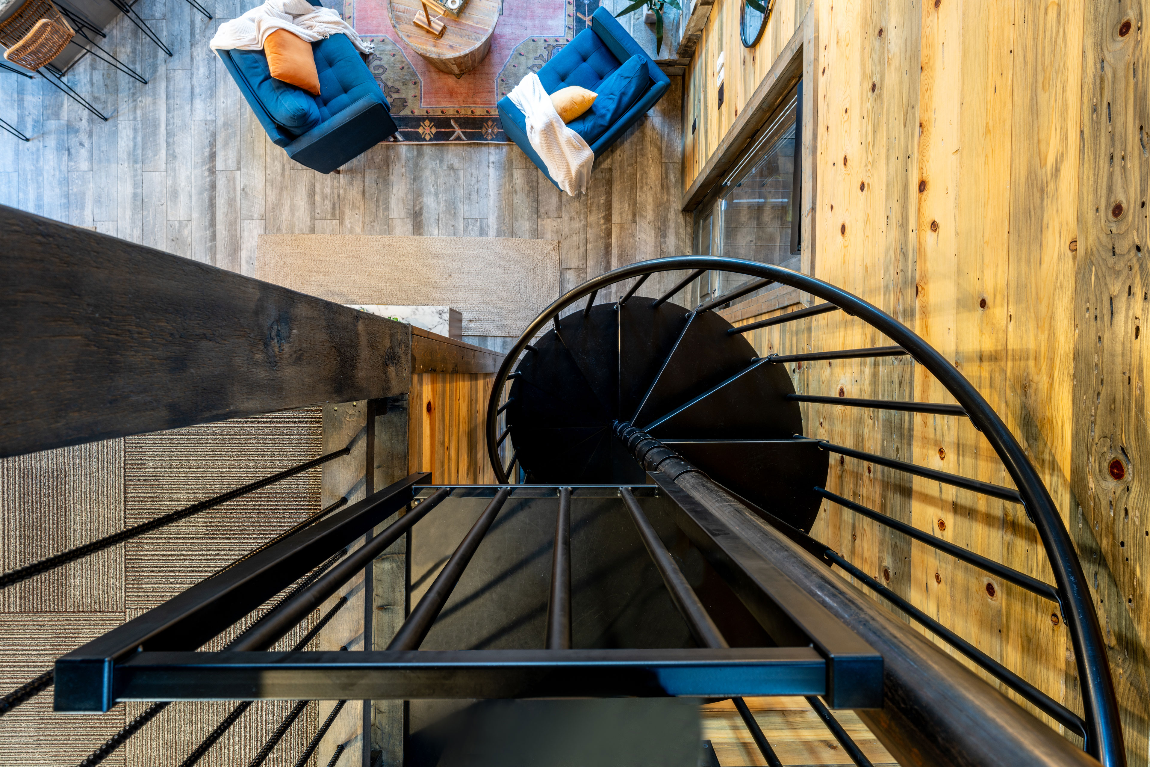 The modern spiral staircase gives access to the loft bedroom with four single bunkbeds and arcade with smart TV.
