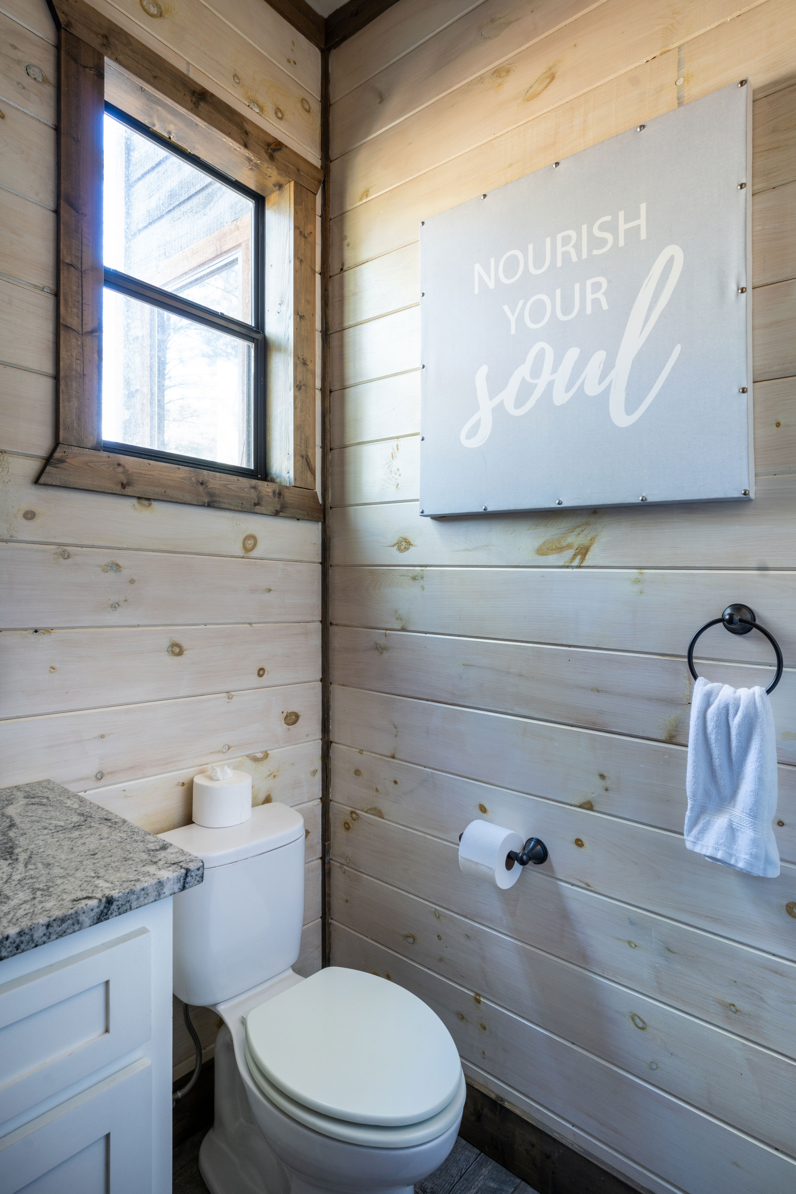 This bathroom, set off from the living room for all to use, features sleek design elements and a bathtub with a showerhead. It's fully stocked with body wash, shampoo, conditioner, towels, and wash cloths for everyone sleeping in the loft.