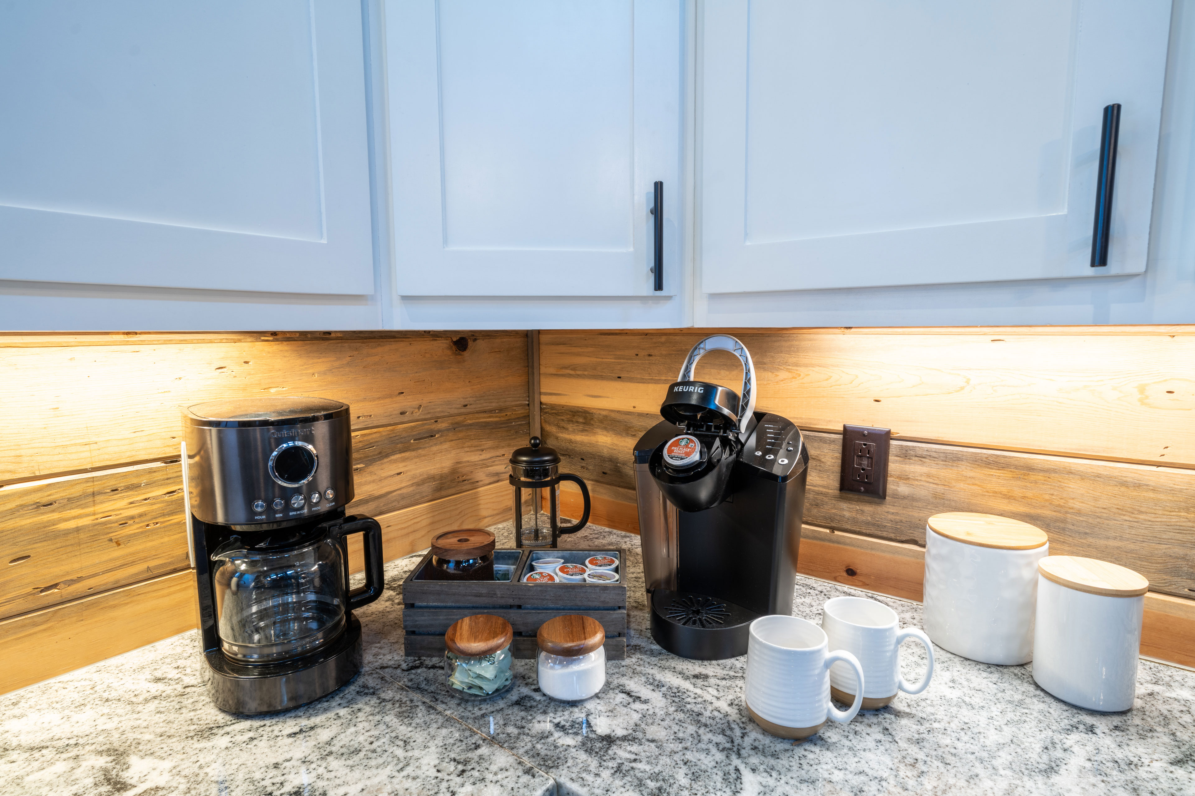 This coffee station includes a black Keurig machine, a traditional coffee maker, and a French press. We provide enough coffee, creamer, and sugar to get your vacation going. 