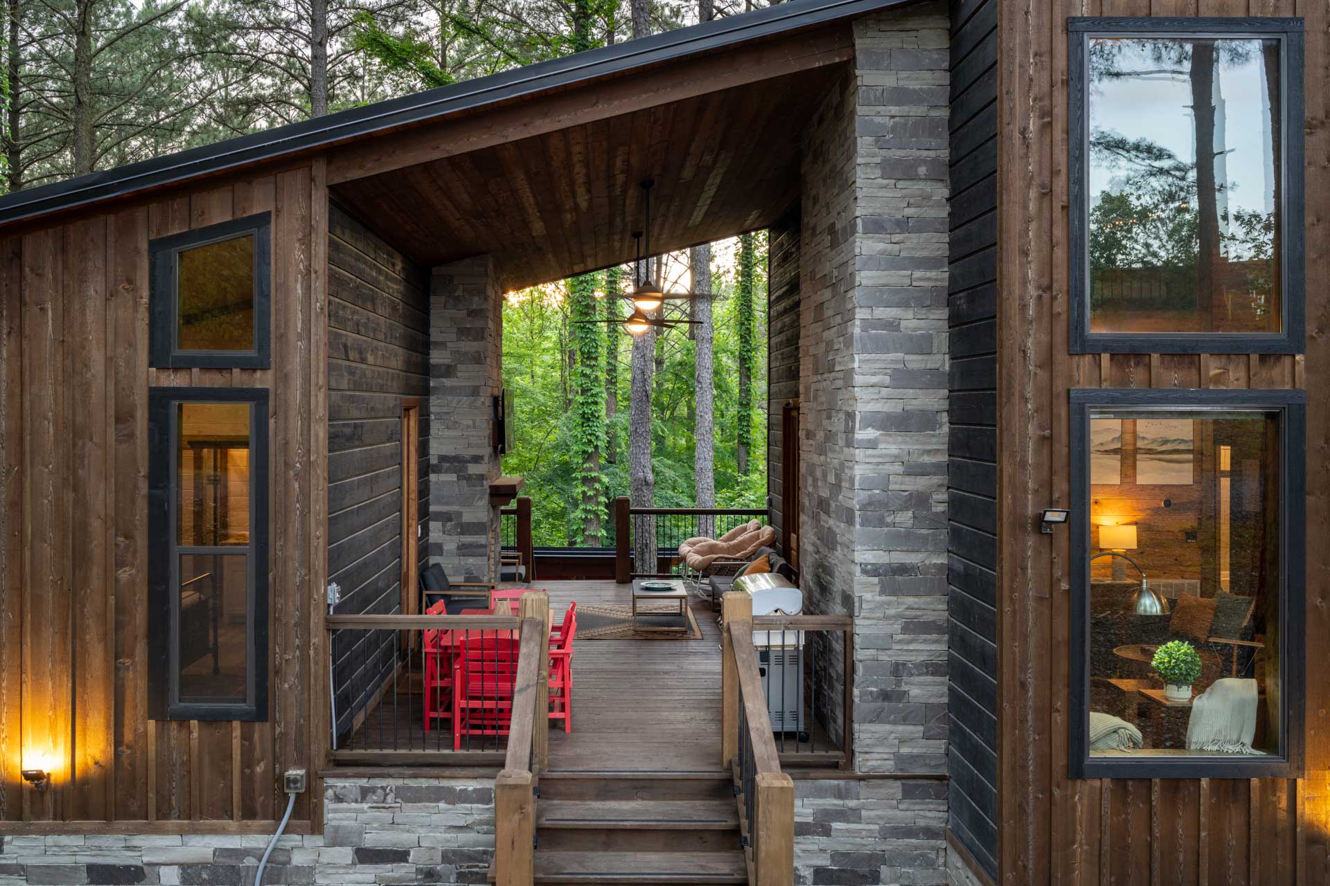 A beautiful breezway connects the two sides of the cabin. On the left, there are doors to separate king suites and on the right is the door to the living room, kitchen, loft, and another king suite.