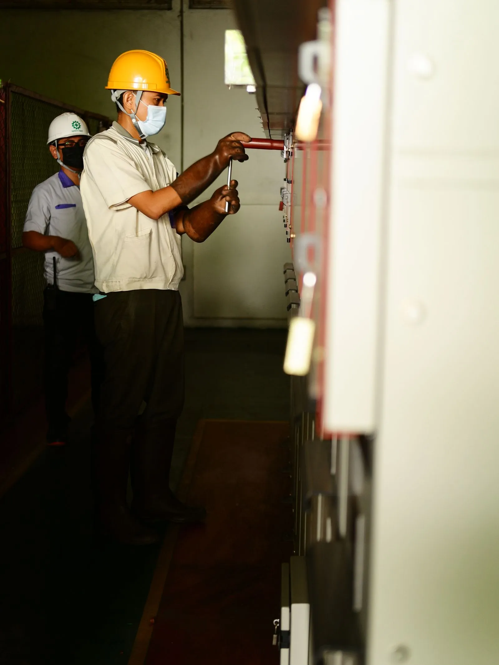 Technicians inspecting commercial electrical and life safety control panels