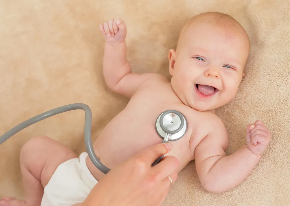 baby smiling with stethoscope