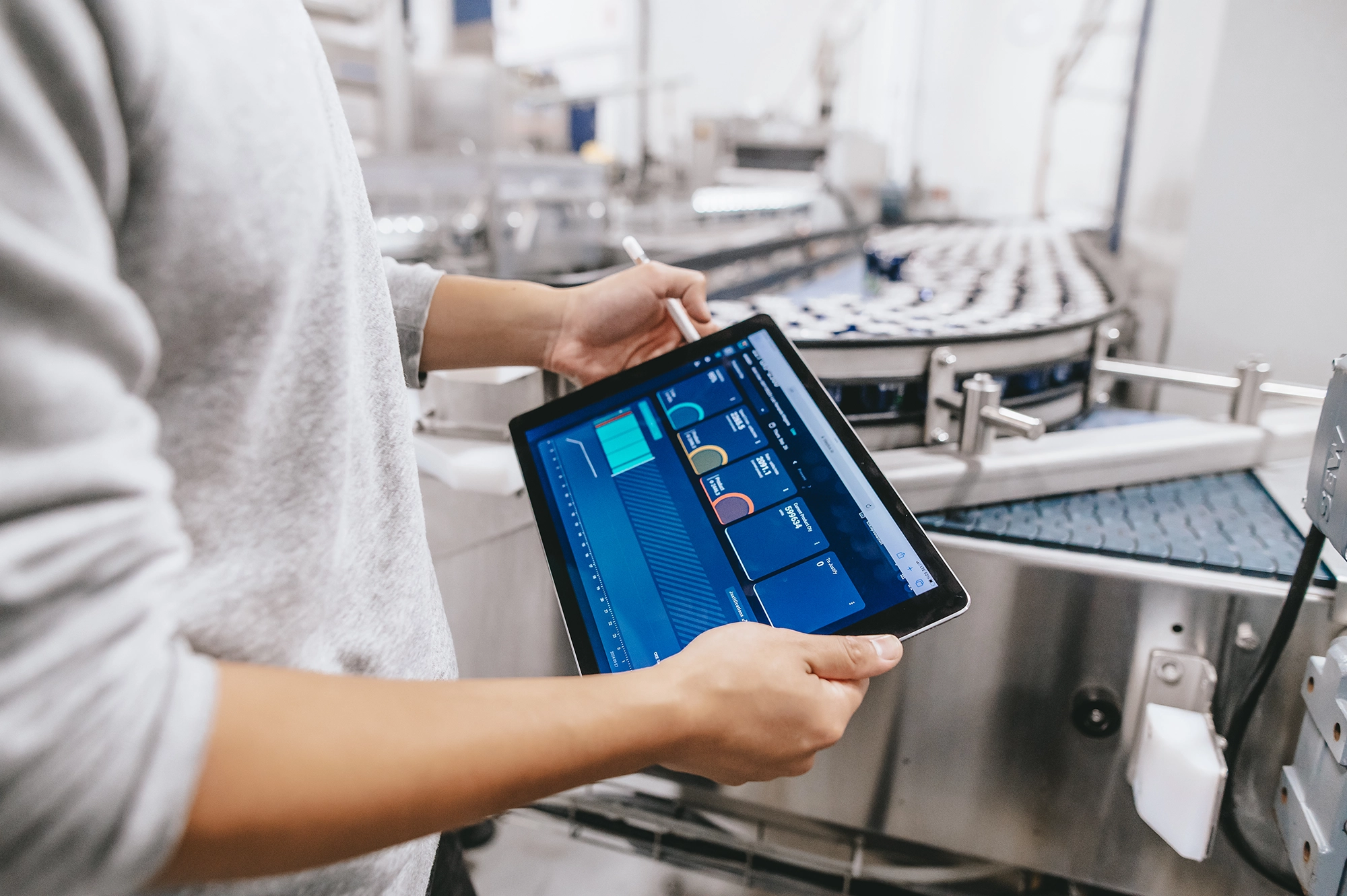 Person using a tablet beside stainless-steel brewing equipment Brasseurs du Nord Boreale
