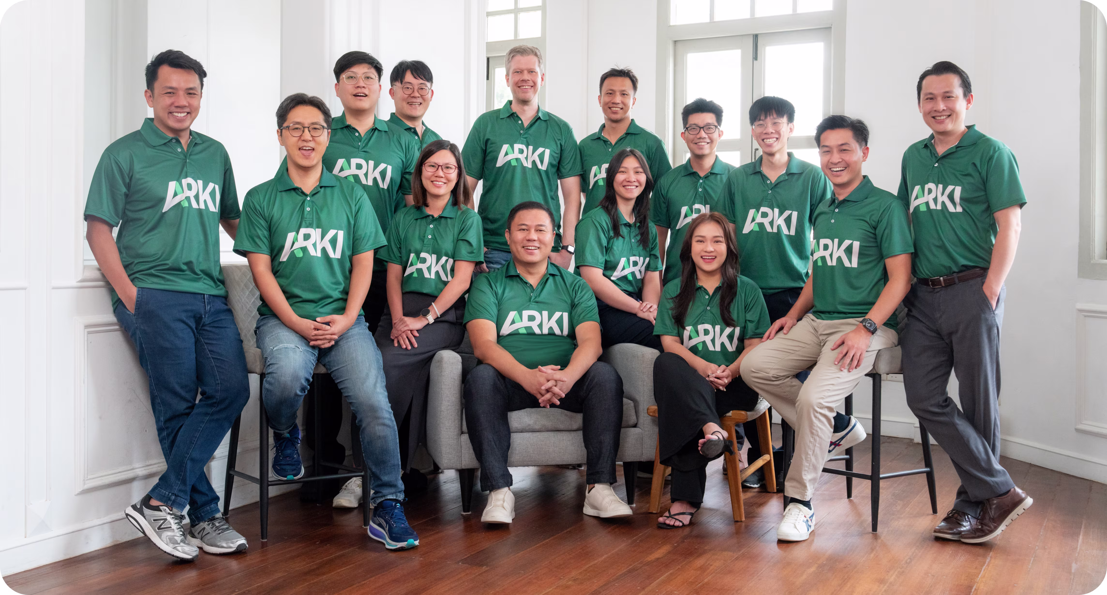 Arki Finance official core company team group photograph standing together.