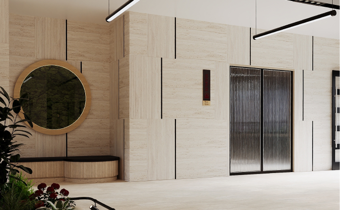 Modern lobby featuring textured walls, round mirror, black bench, plants, and two pendant lights.