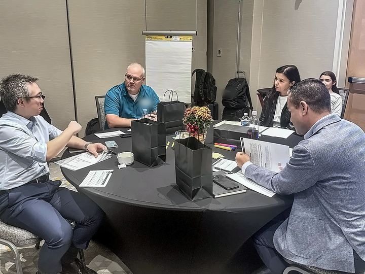 Leaders mid-conversation at a round table