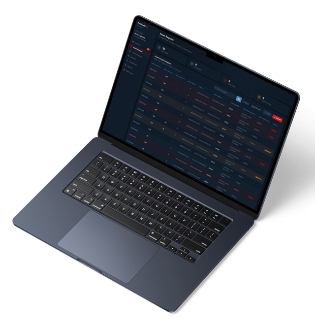 Open laptop showing a dark-themed asset register dashboard with data tables.