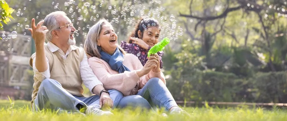 Family laughing together with a bubble machine