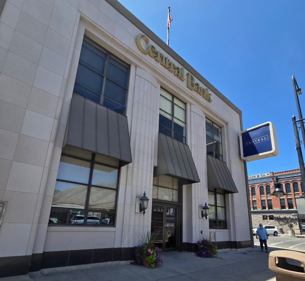 Exterior of Central Bank building with awnings over windows and U.S. flag on roof.
