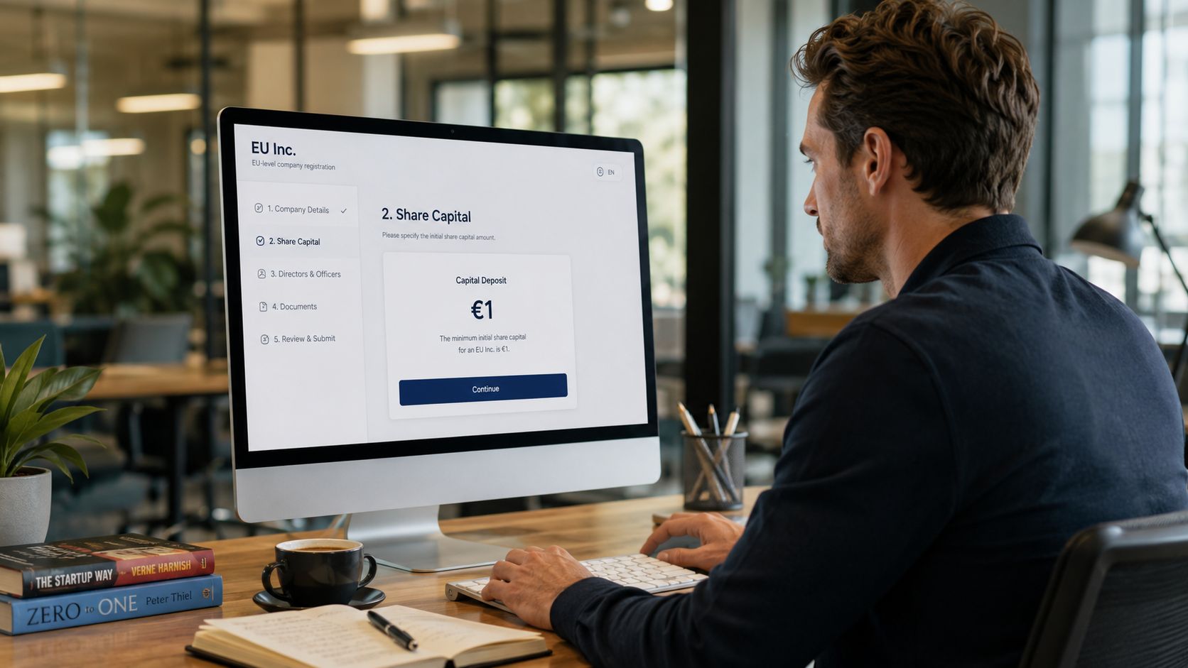 A professional man sitting at a wooden desk working on an EU Inc company registration website.