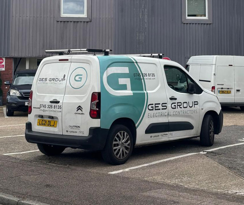 GES Group branded electrical contractor van parked outside a commercial building, representing professional commercial, industrial and residential electrical services.