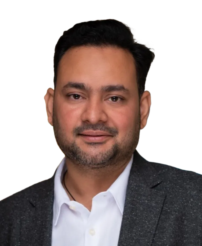 Portrait of a man with short black hair, trimmed beard, wearing a white shirt and dark blazer.