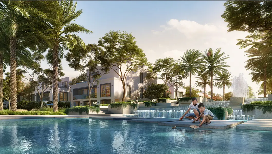 Clear blue swimming pool surrounded by lush tropical landscaping and modern luxury homes