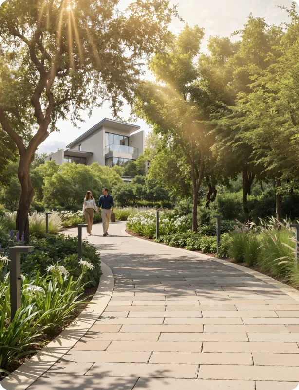 Couple walking along a paved stone pathway in a luxury residential park amenity