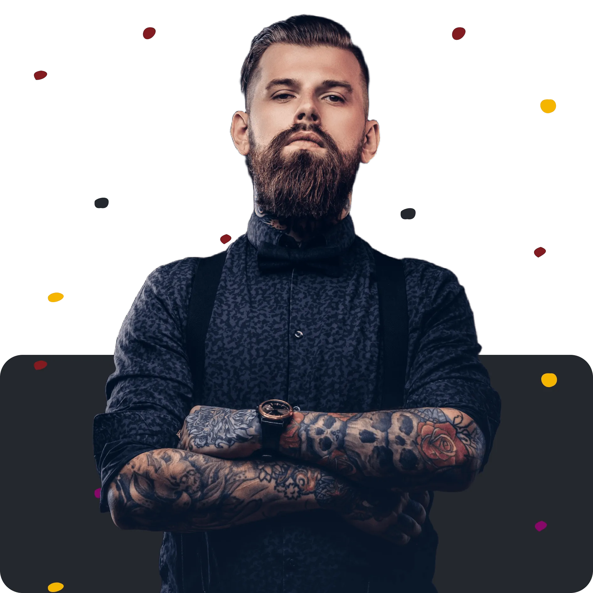 Bearded man with tattooed arms, wearing a black shirt, bow tie, suspenders, and a wristwatch.