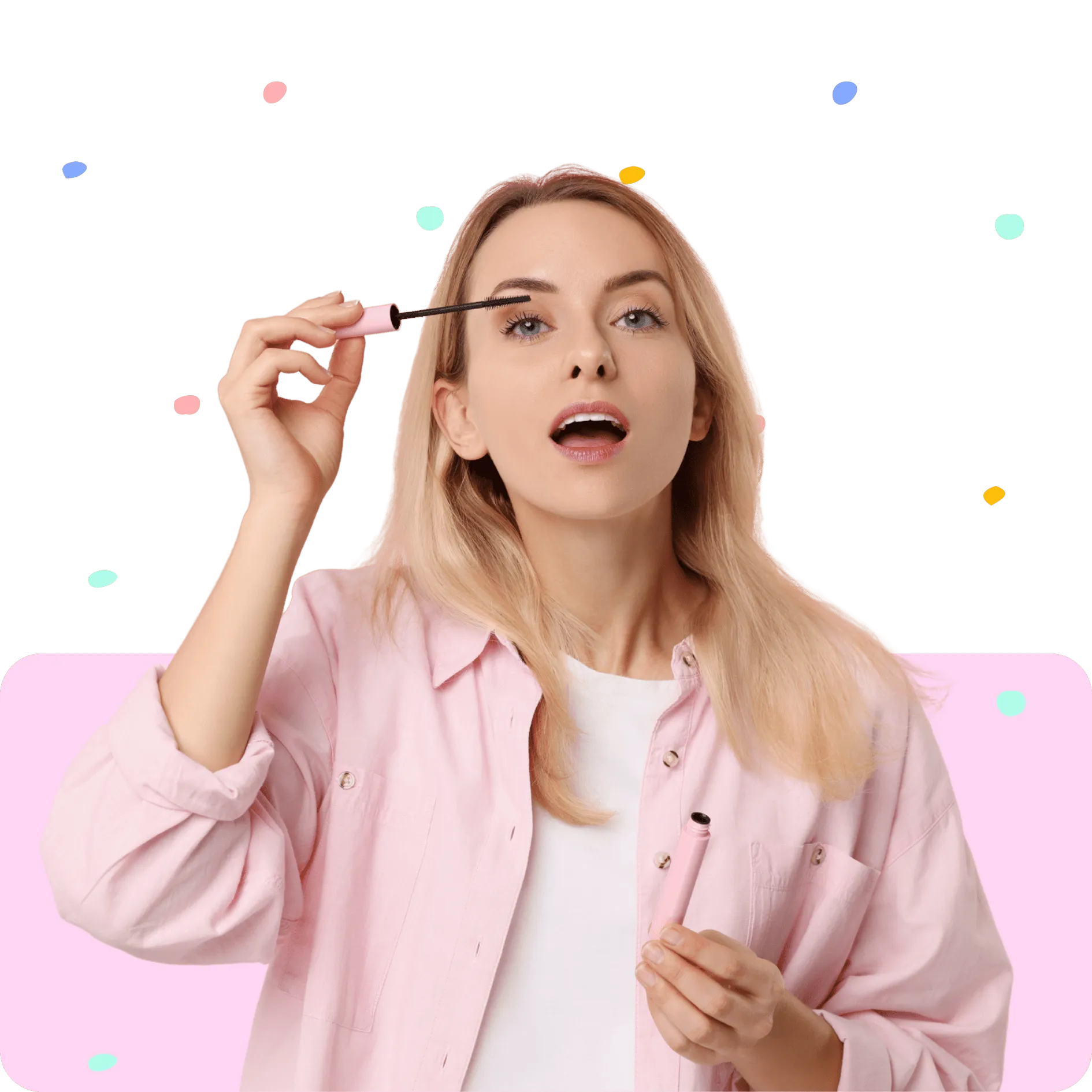 Woman with blonde hair applying mascara to her eyelashes wearing a pink shirt and white top.