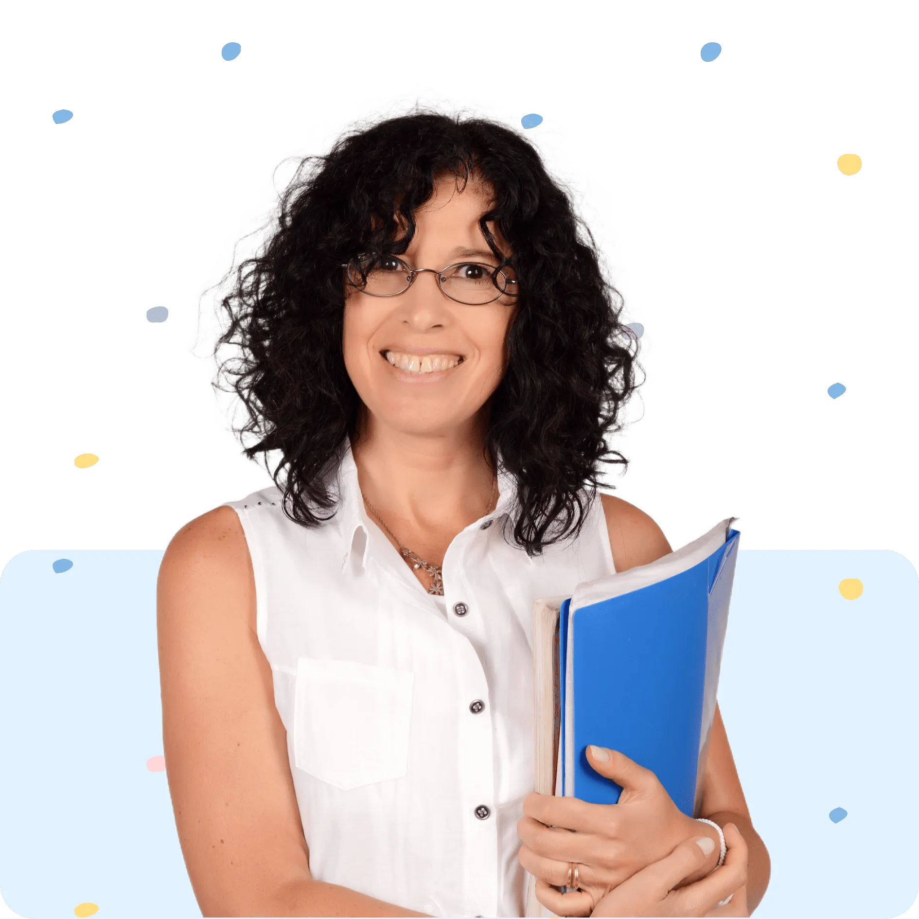 Smiling woman with curly dark hair and glasses holding blue folder and papers in white sleeveless shirt.