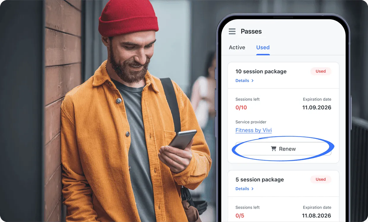 Man in orange jacket and red beanie smiling and looking at phone, app shows expired fitness session passes.