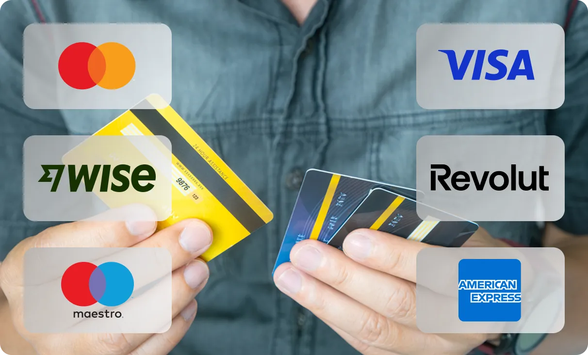 Person holding multiple credit cards with Mastercard, Visa, Wise, Revolut, Maestro, and American Express logos.