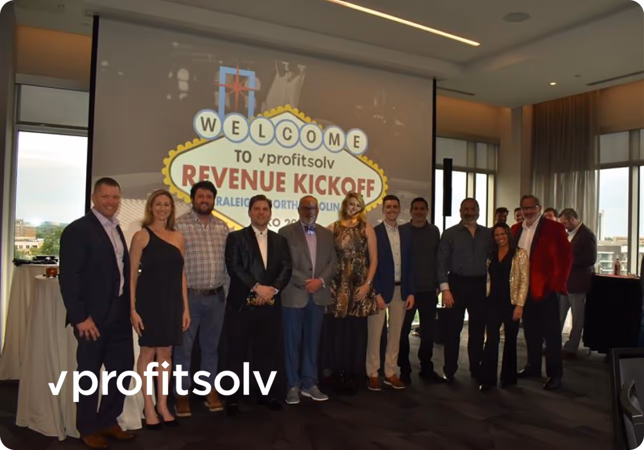 Group of people posing indoors at ProfitSolv Revenue Kickoff event in Raleigh, North Carolina.