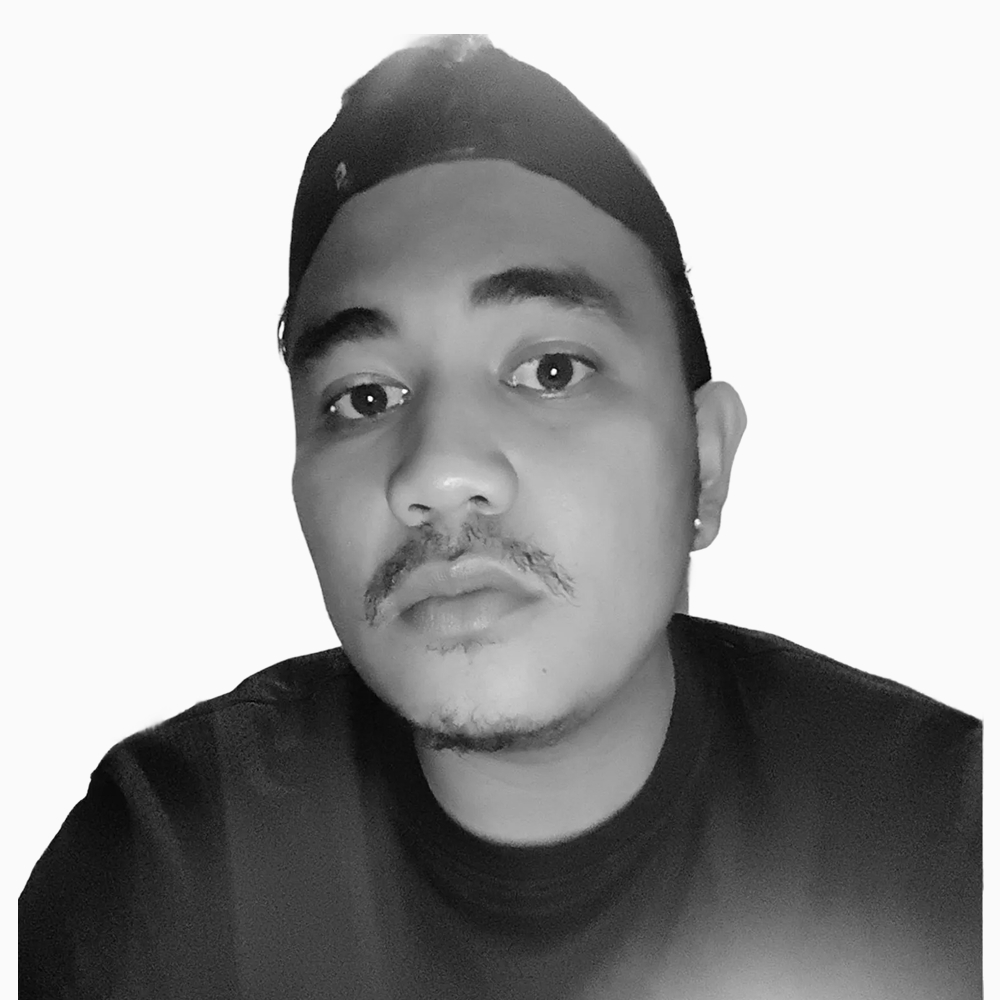 Professional black and white headshot of Christopher, Sales Development Manager at Key Outreach, wearing a dark crew neck shirt and backwards cap while posing against a light gray background.