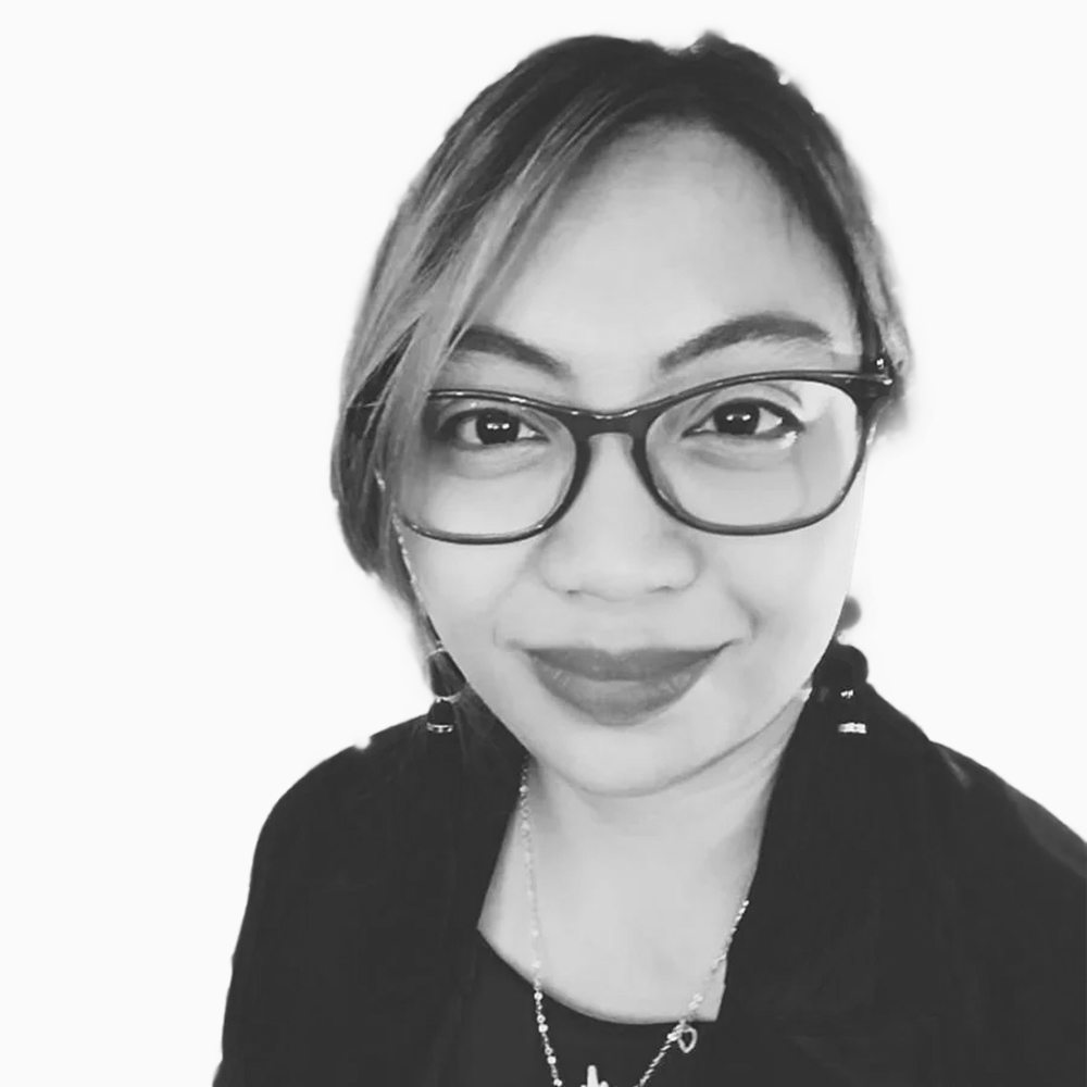 Professional black and white headshot of Jessa, Sales Development Representative at Key Outreach, wearing glasses and a dark blazer while smiling against a light gray background.
