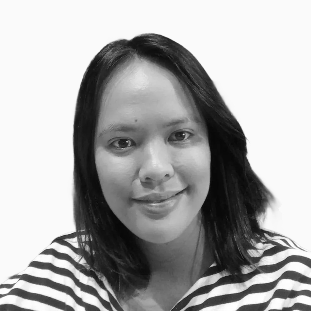 Professional black and white headshot of Joy, Sales Development Representative at Key Outreach, smiling while wearing a striped shirt against a light gray background.