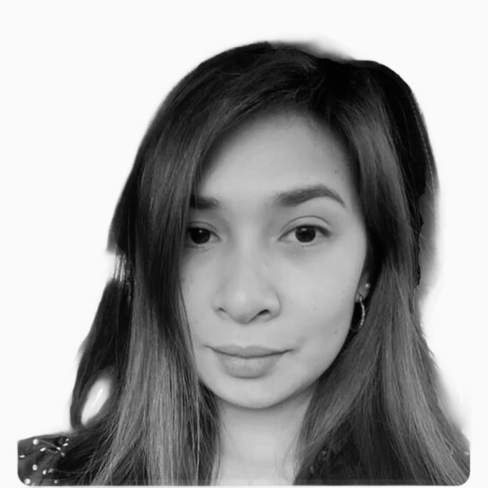 Professional black and white headshot of KC, Sales Development Manager at Key Outreach, wearing hoop earrings and a dark patterned top while posing against a light gray background.