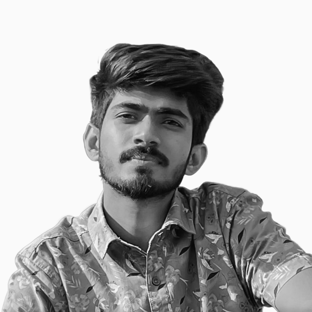 Professional black and white headshot of Sabbir, Technical Support team member at Key Outreach, wearing a floral patterned button-up shirt while posing against a light gray background.