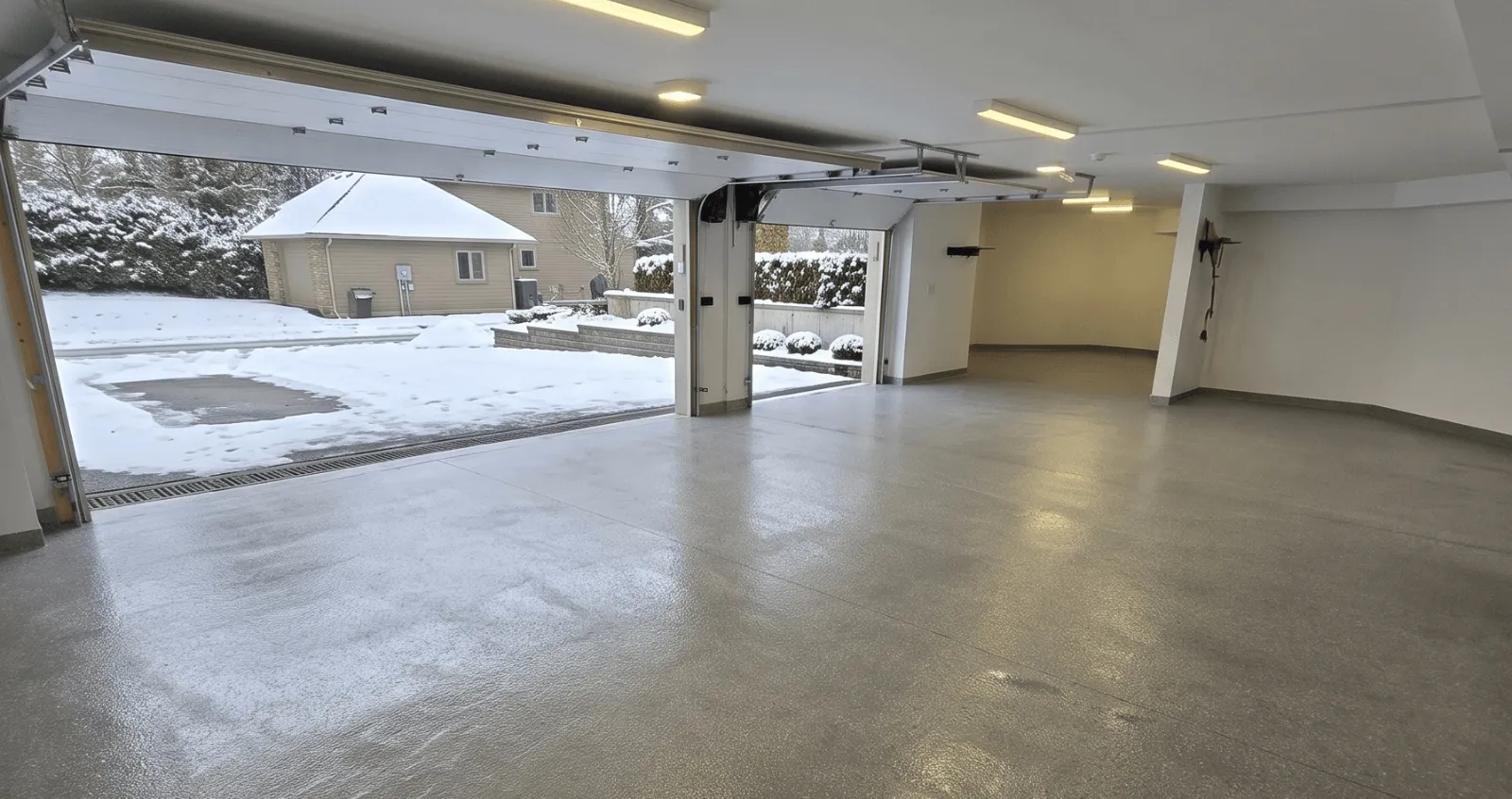 Coated garage floor with snow outside the open door