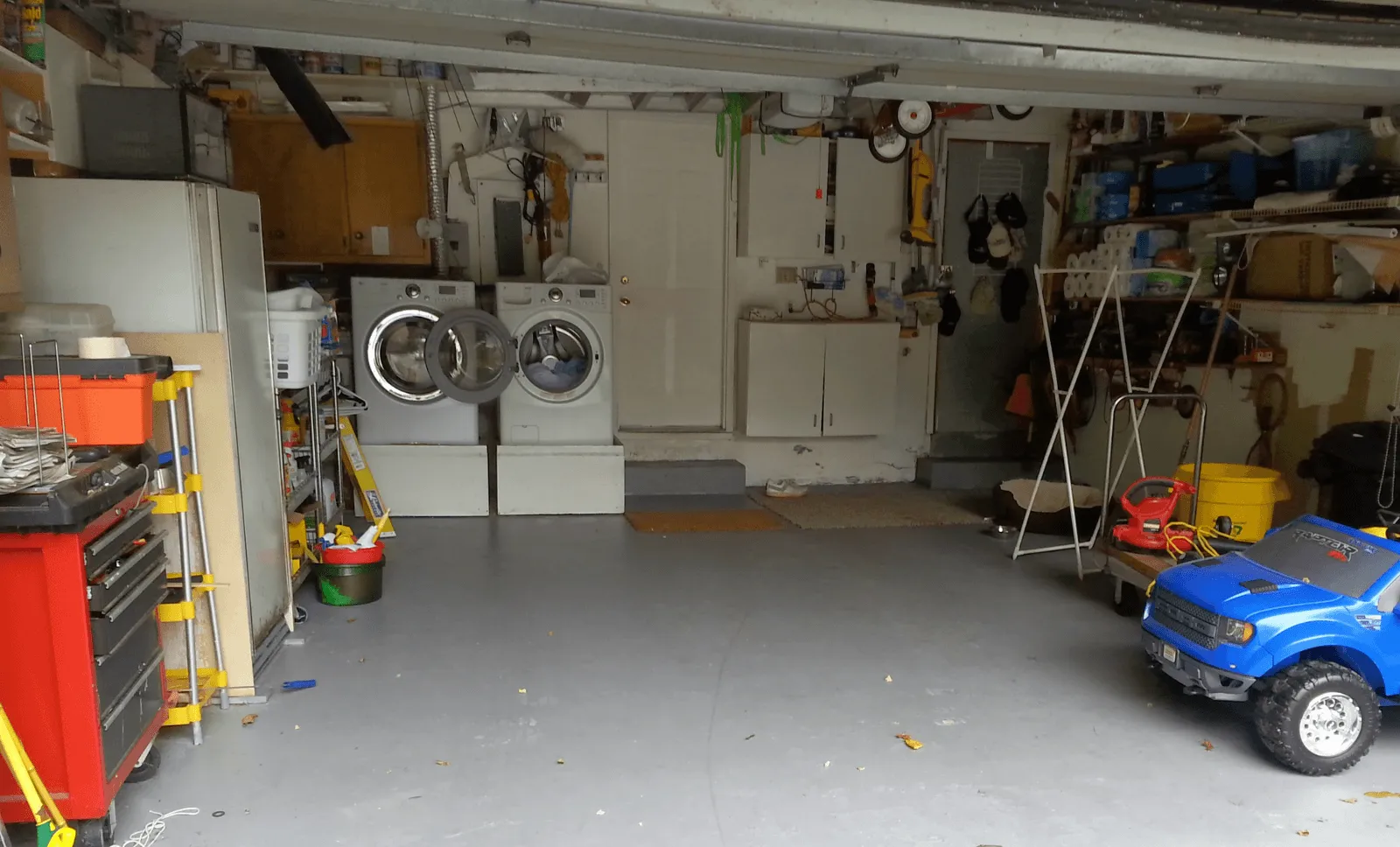 Cluttered unfinished garage before coating