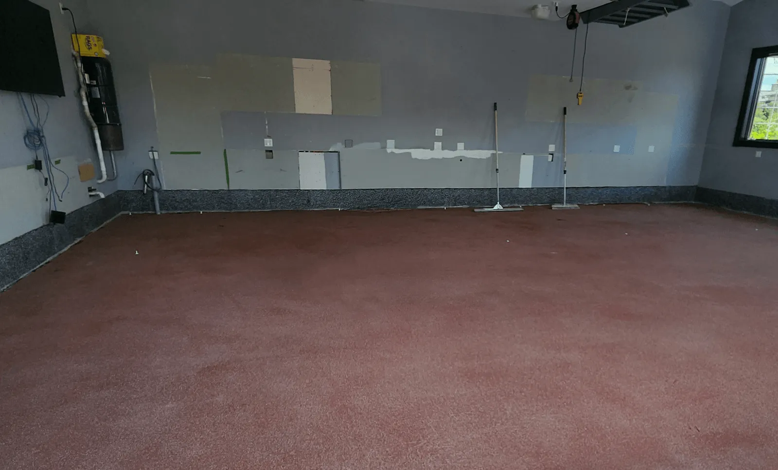 Dusty bare concrete garage floor before coating