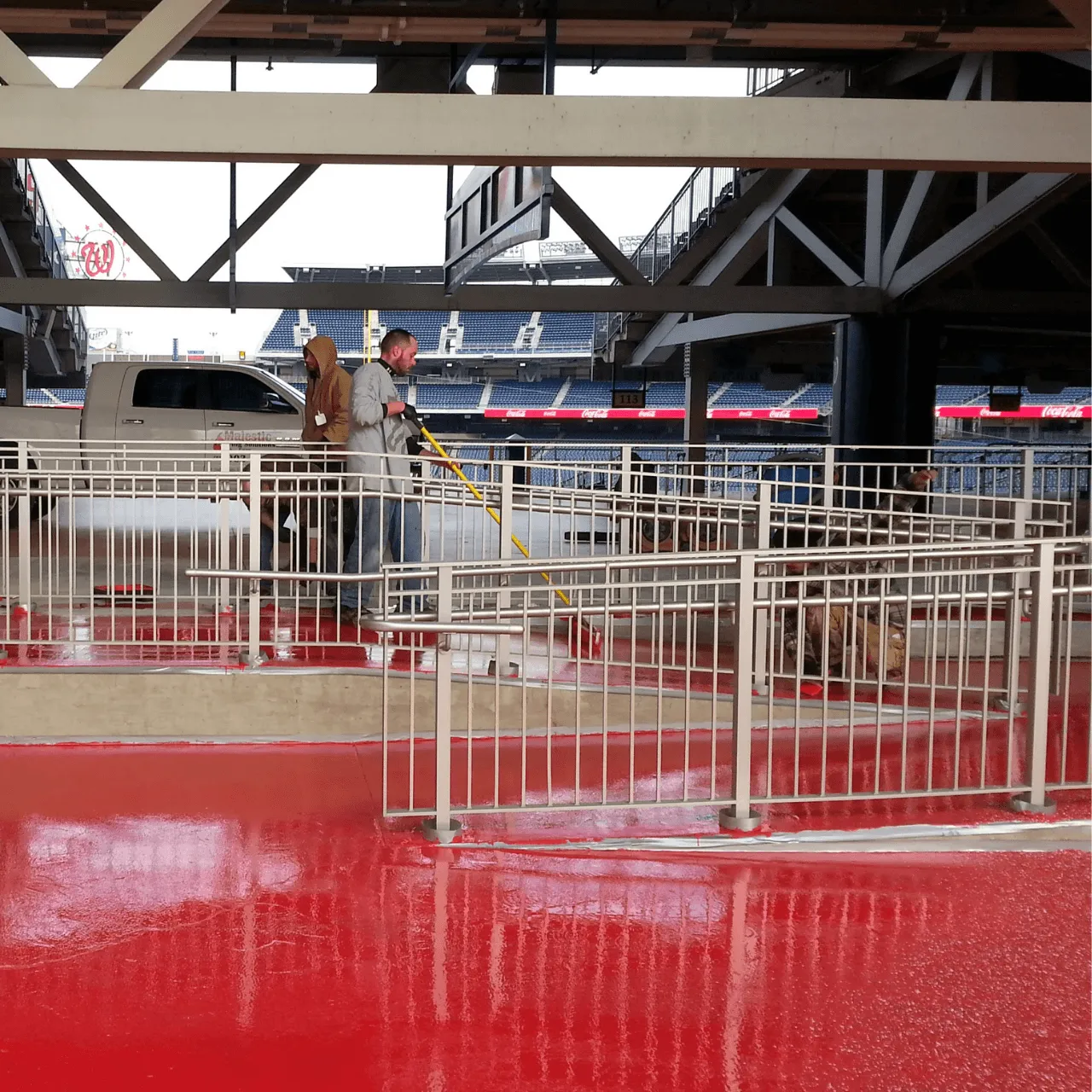 Red coated stadium concourse floor