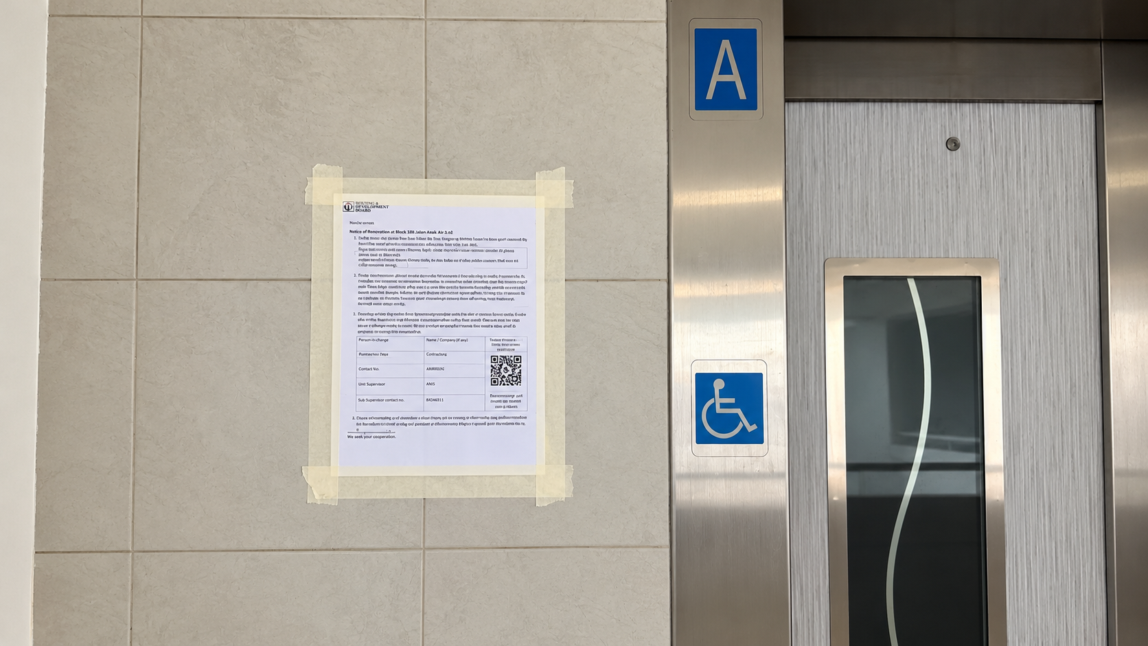 HDB renovation notice displayed beside a lift in a residential block.