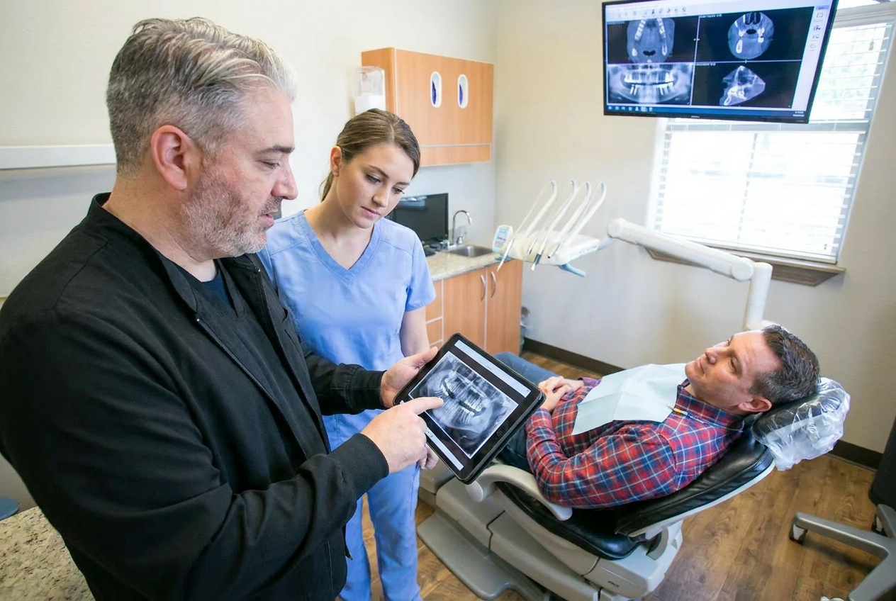 Patient wearing a lead apron while a digital dental x-ray sensor is positioned