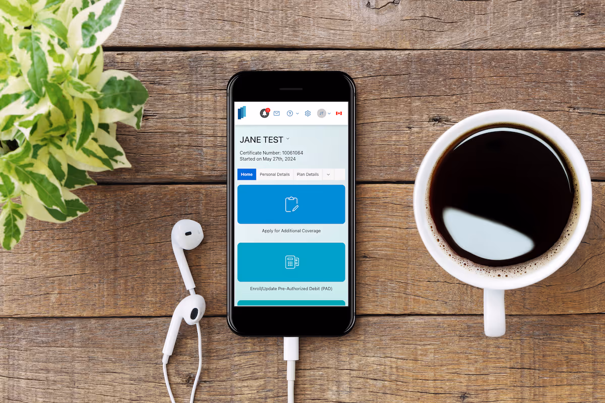 Phone and coffee on a table phone is showing the InsureCPA customer Portal home view 