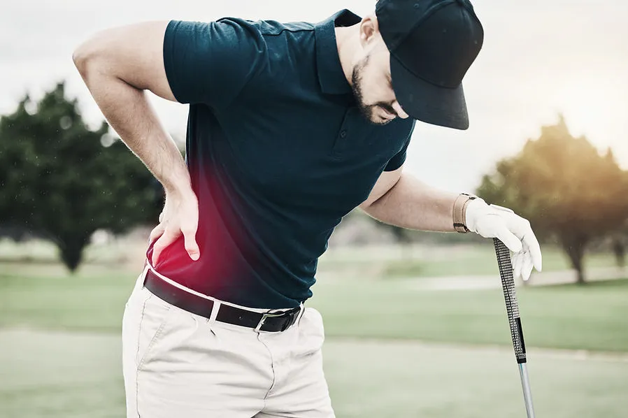 Man on golf course holding his painful back