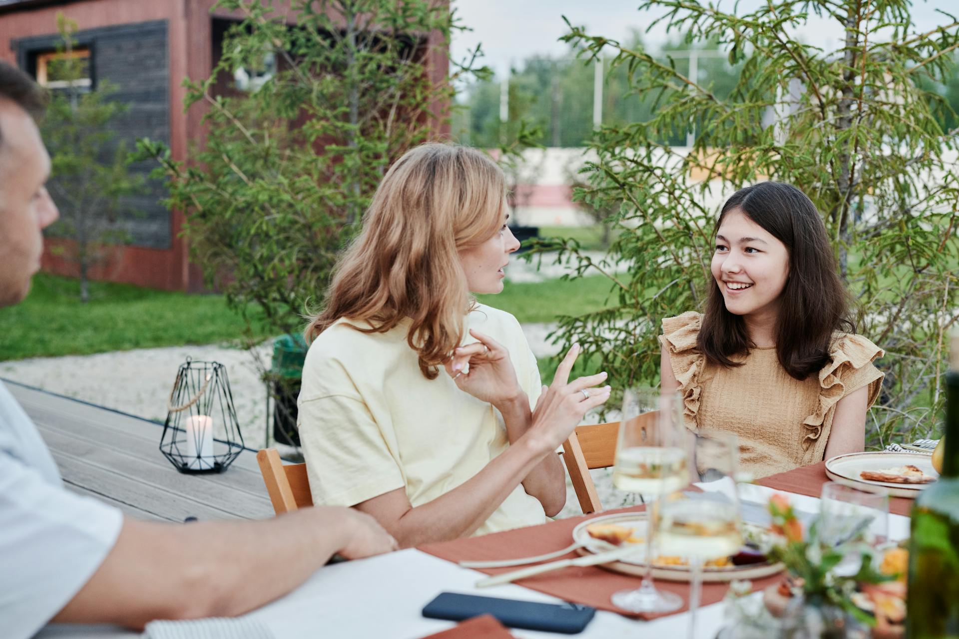Parents having a conversation with their daughter outside