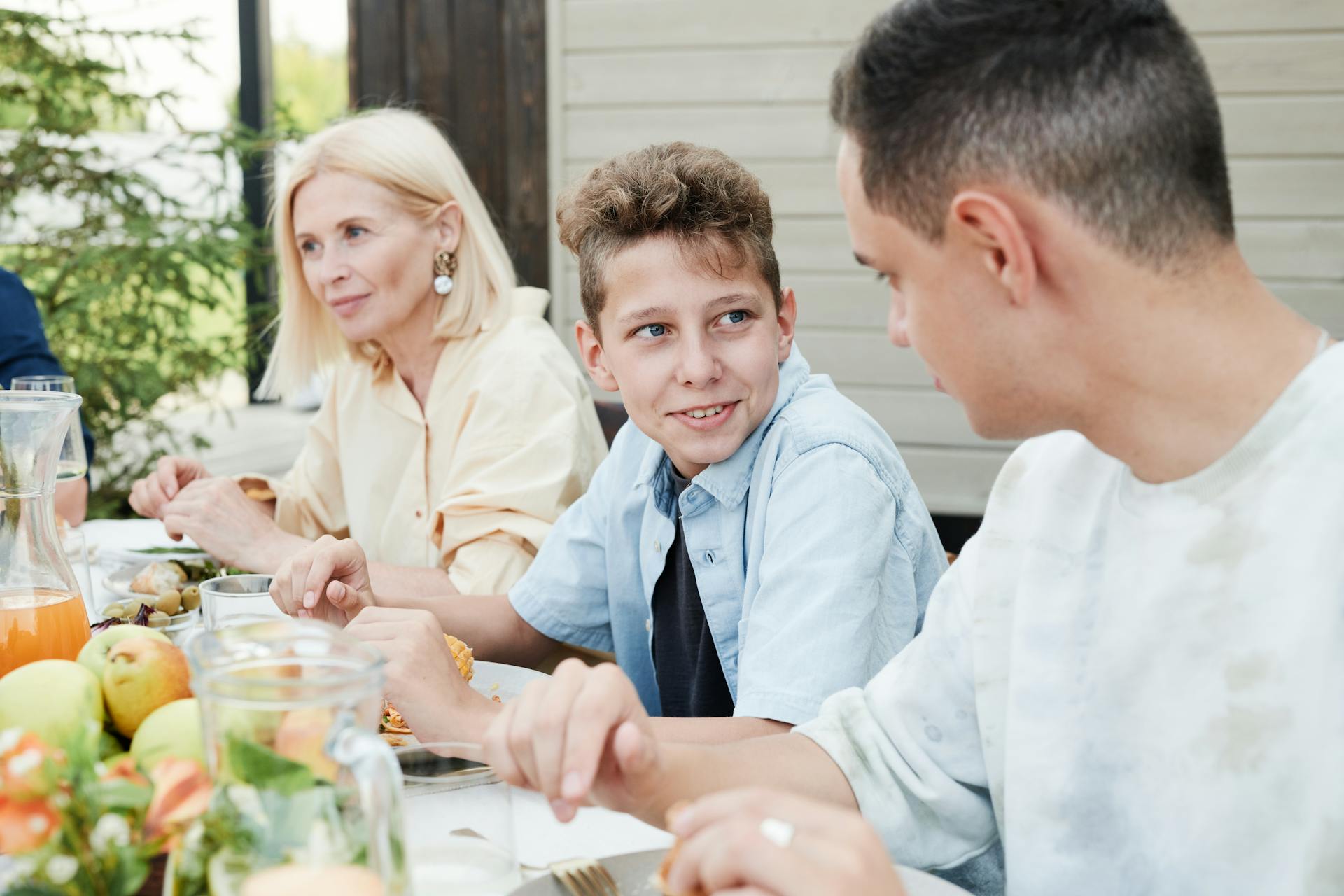 Parents sitting at a table with their son talking